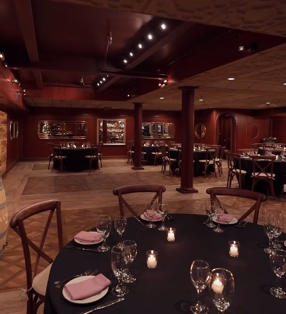 The Tosca Room set with round tables, columns and a parquet floor